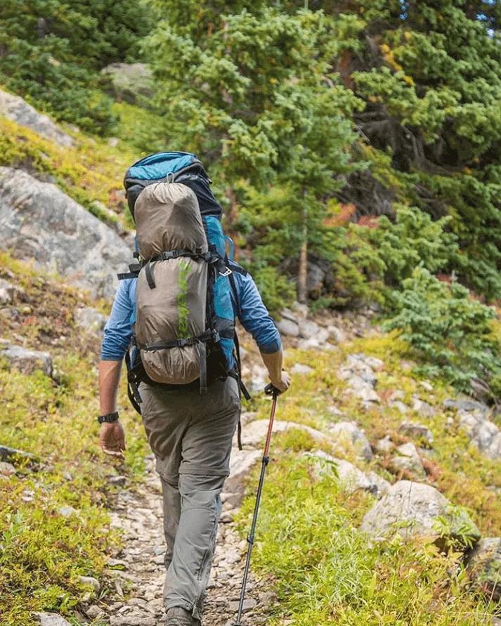 Hiker carrying loaded backpack