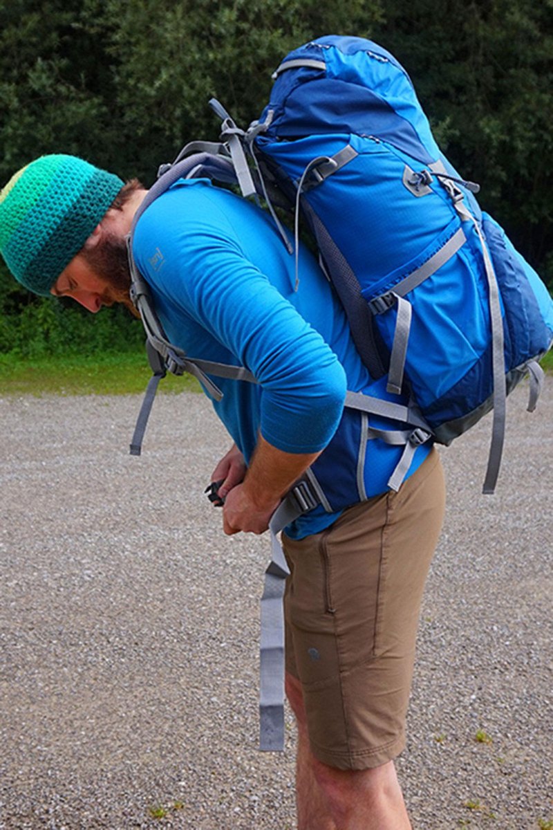 Hiker adjusting balanced backpack load