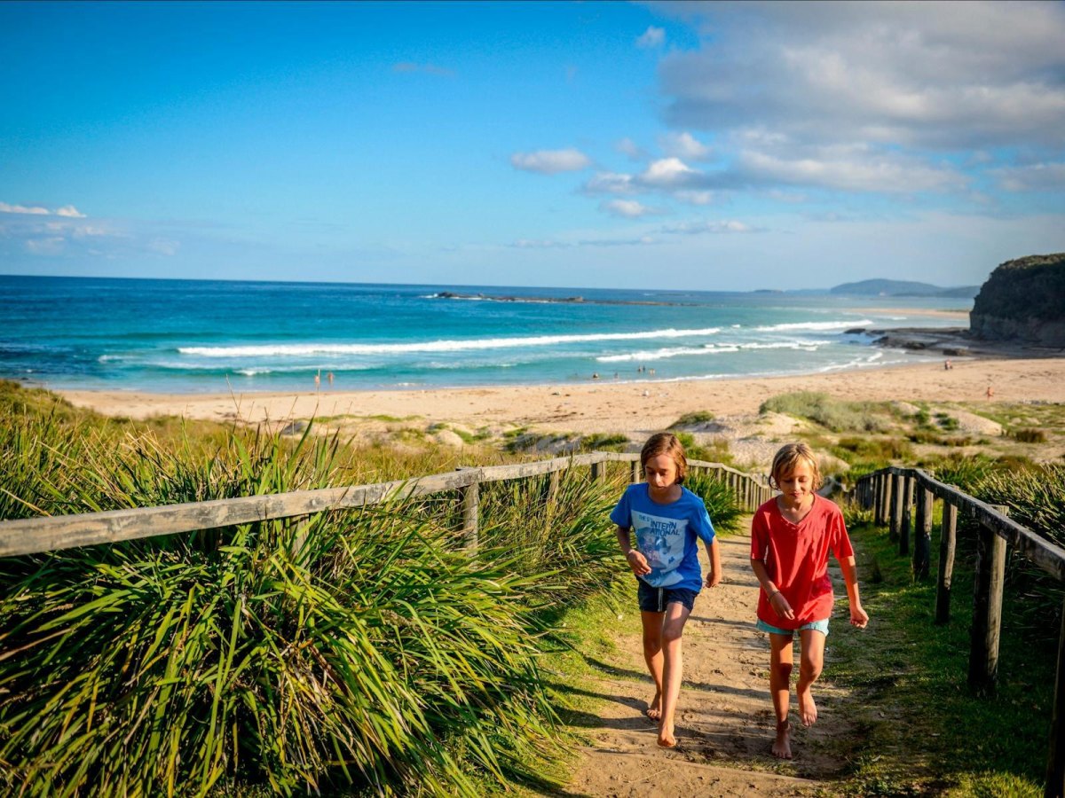 Children walking along a beach nature trail