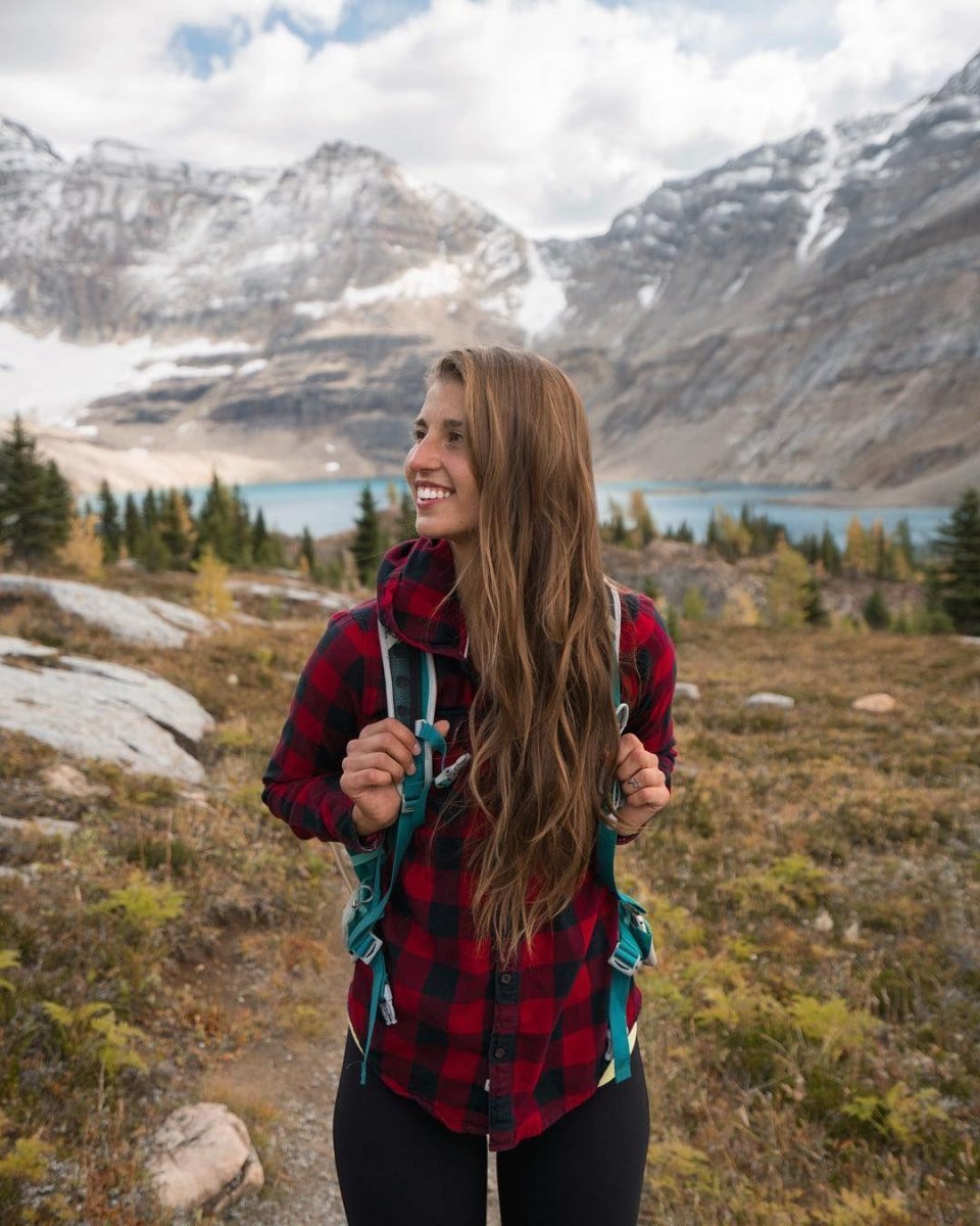 Hiker wearing flannel shirt forest trail