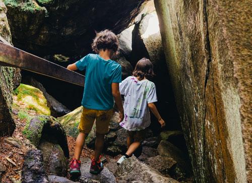 Family exploring a rocky cave trail