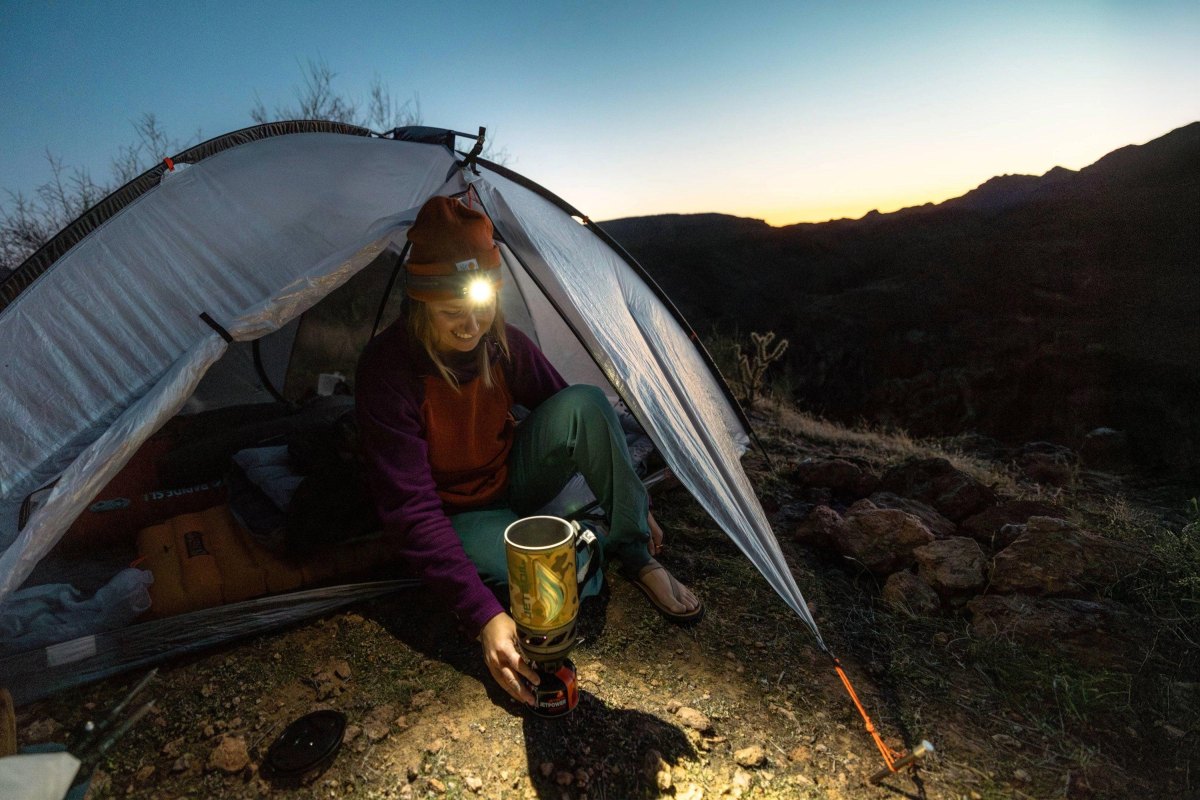 Hiker wearing headlamp at dusk