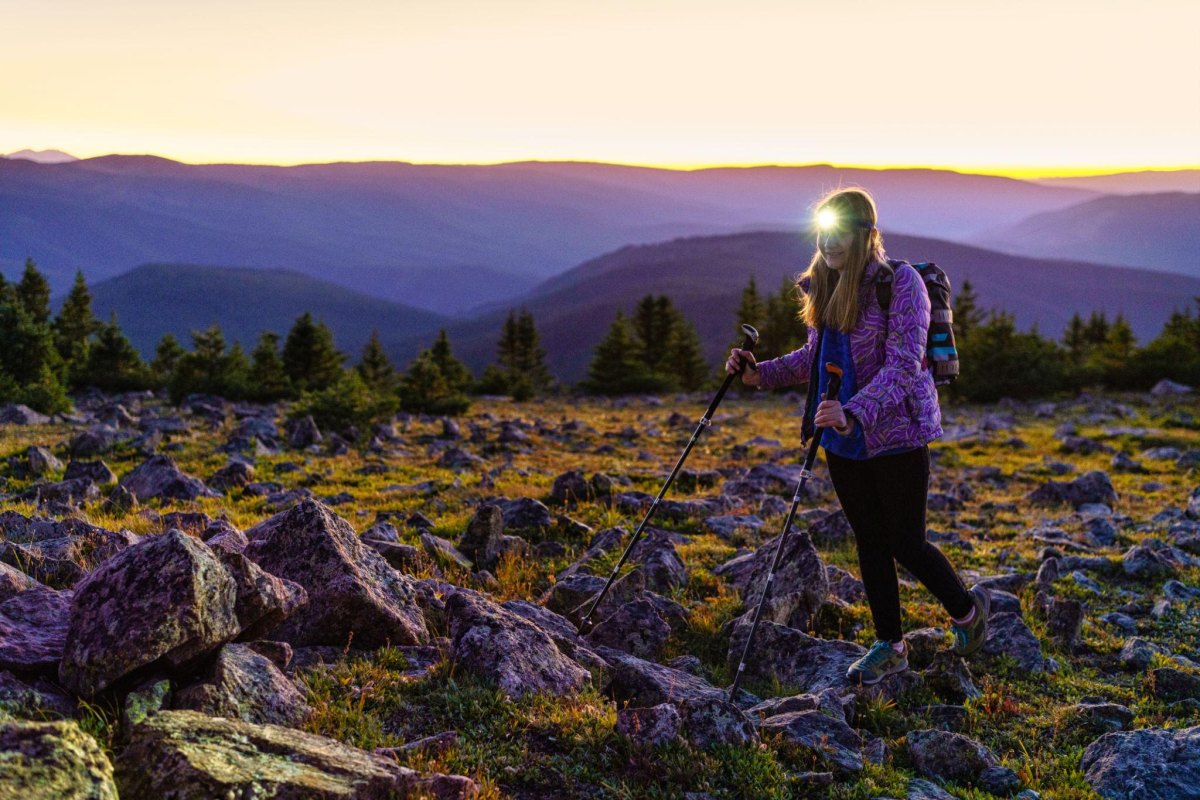 Female hiker wearing headlamp