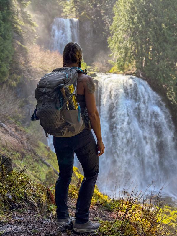 Hiker with gear waterfall