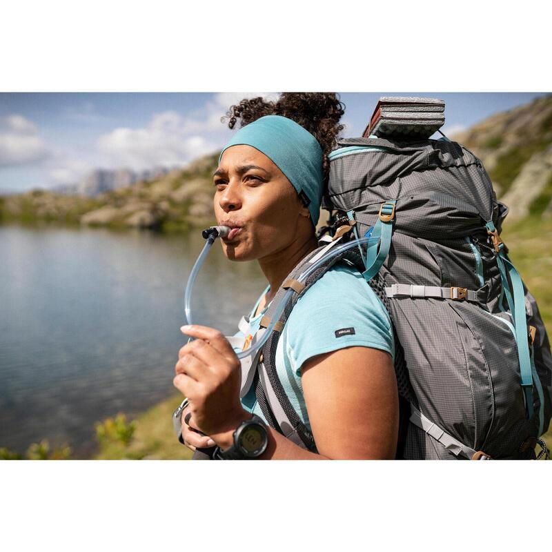 Woman drinking water with hydration pack