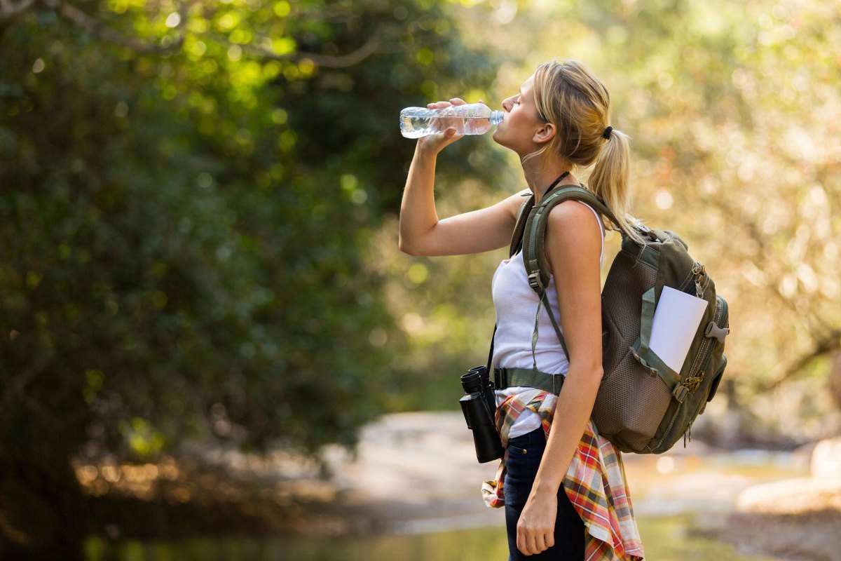 Female hiker drinking water outdoors