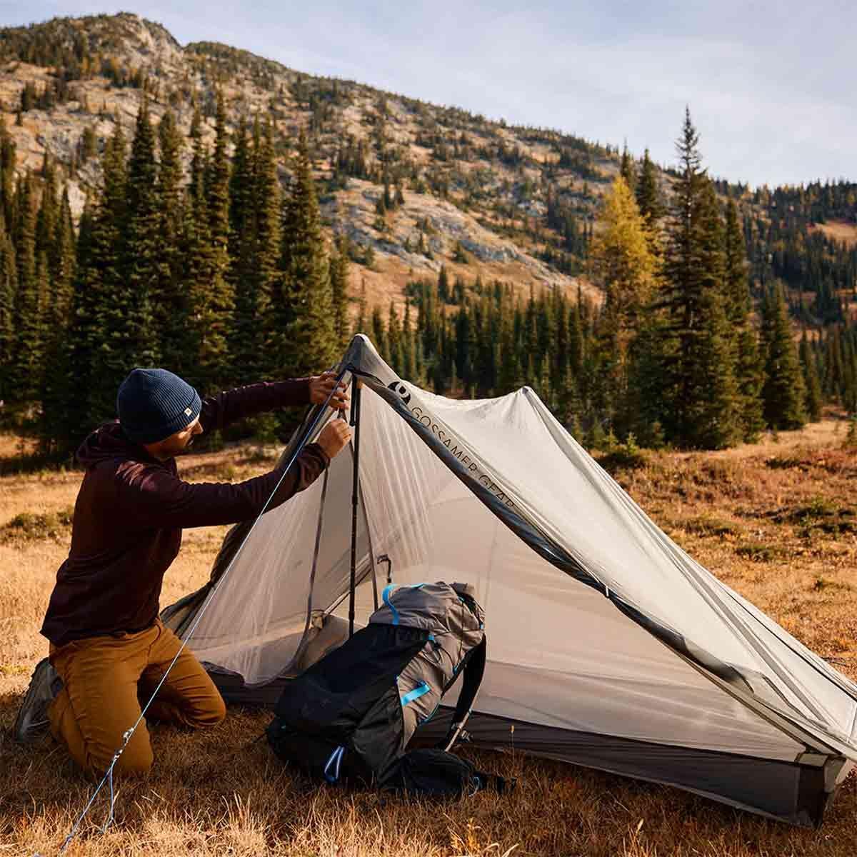 Hiker checking navigation route while backpacking outdoors