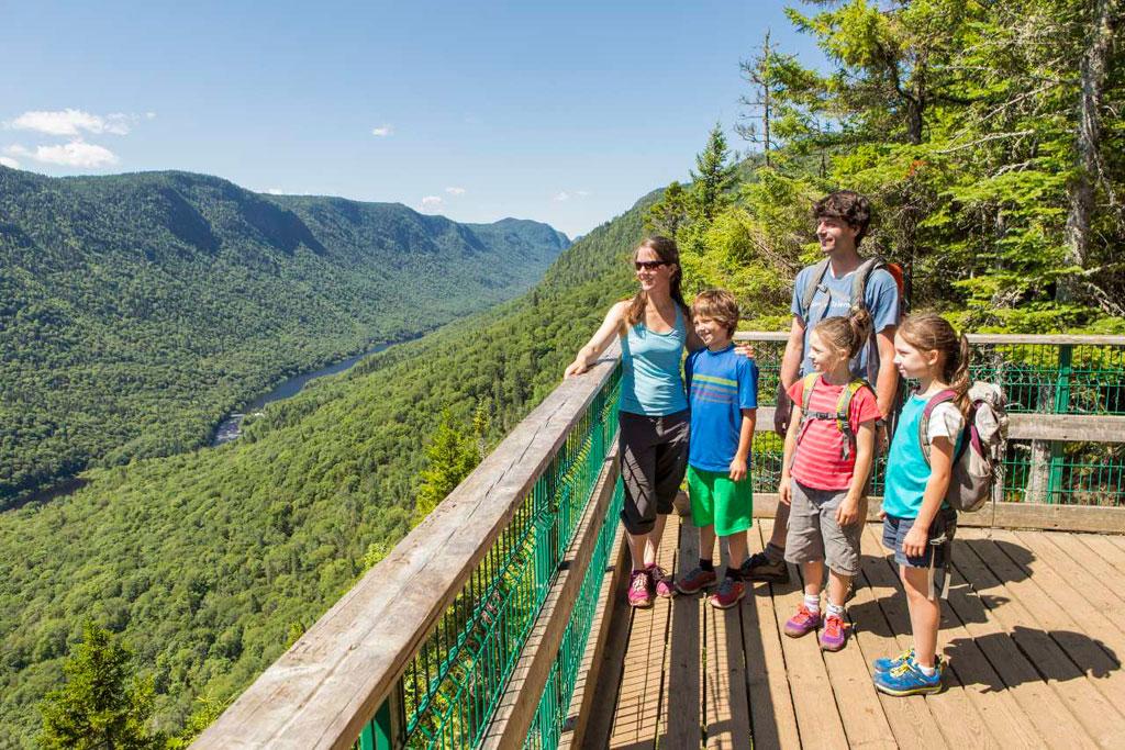 Family hiking toward a mountain viewpoint