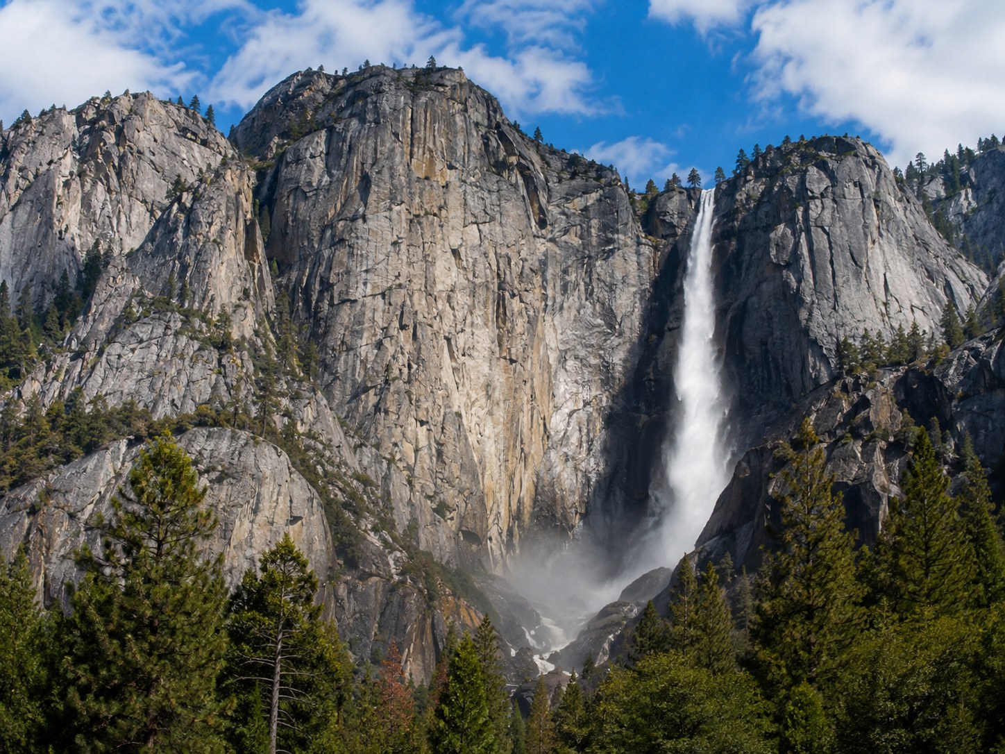 Upper Yosemite Fall dropping from granite cliffs in Yosemite National Park, California