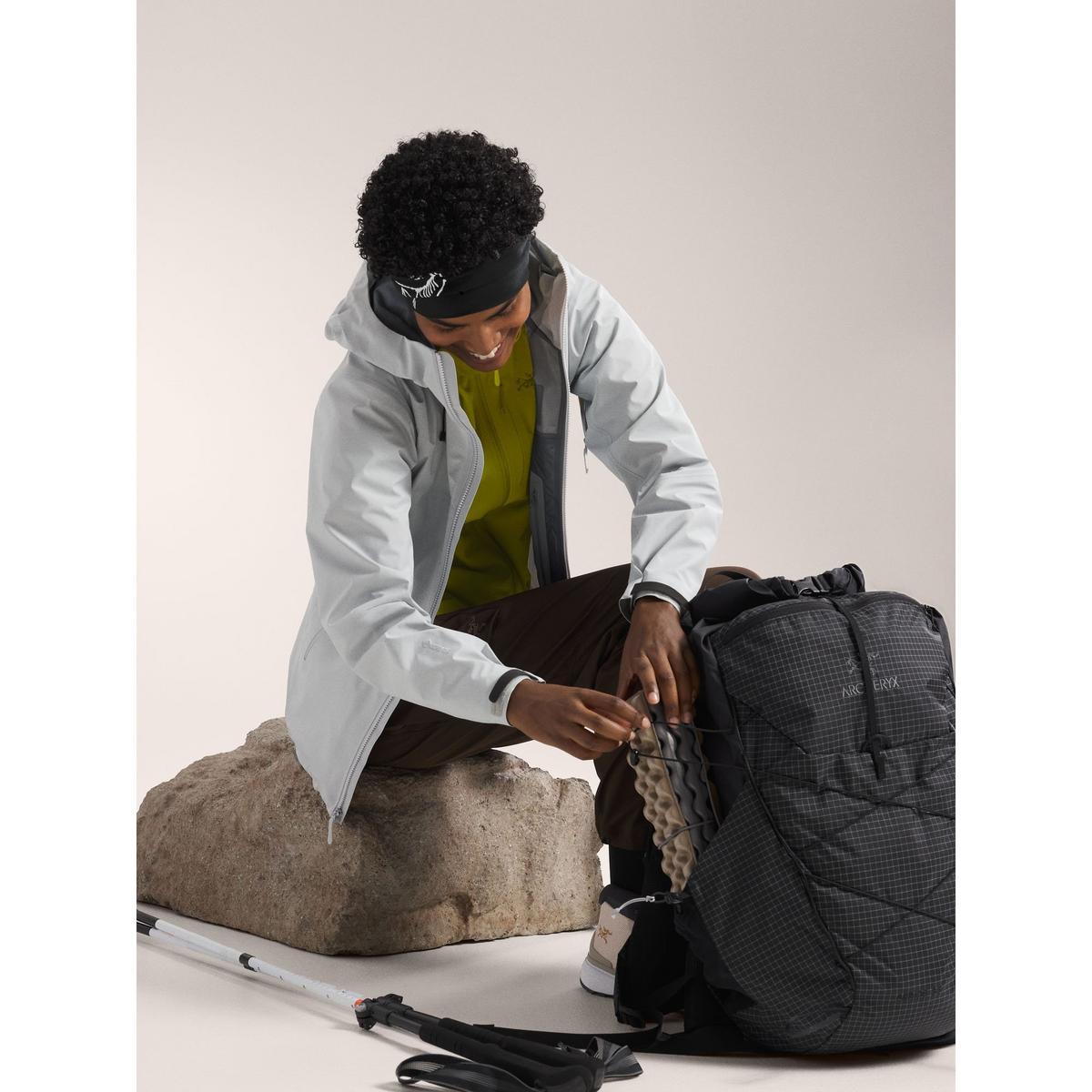 Hiker packing rain protection gear