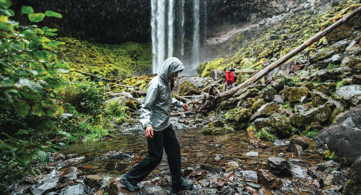 Hiker wearing rain jacket forest