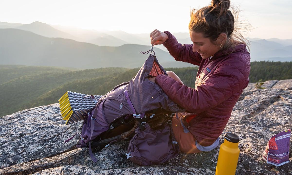 Hiker reviewing backpack gear