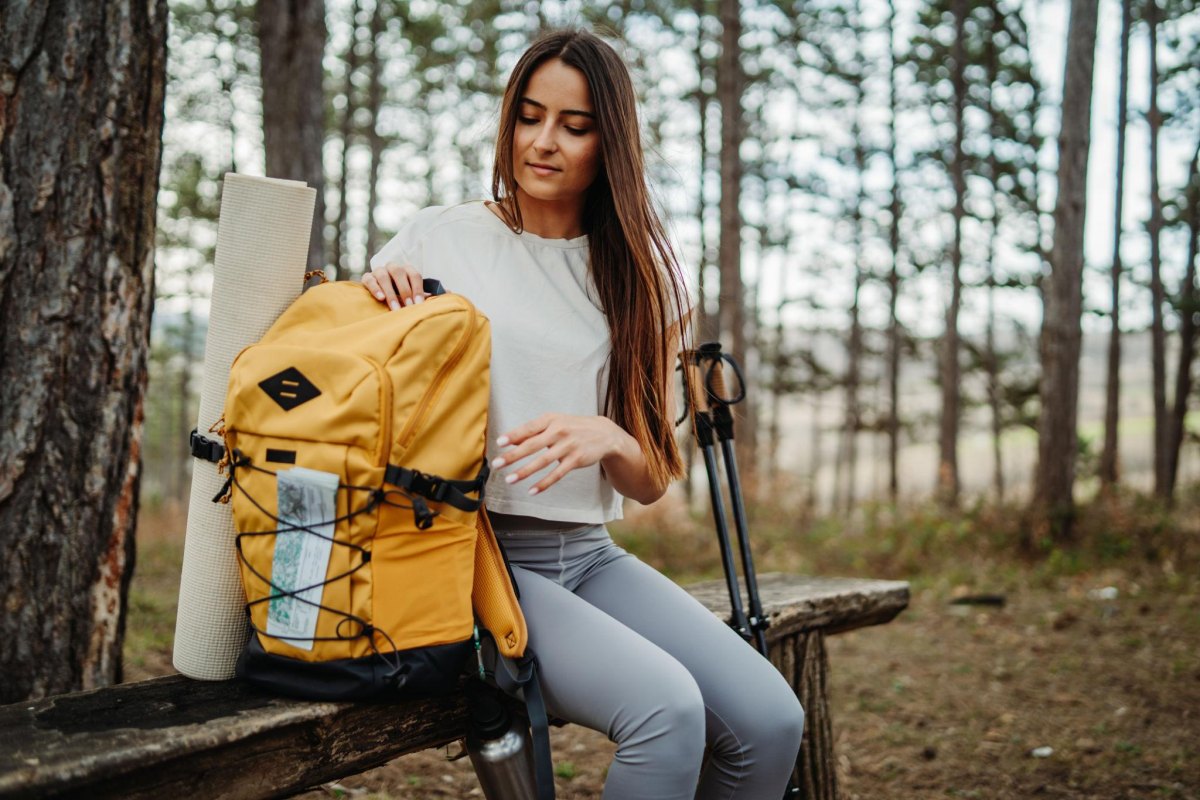 Woman checking hiking checklist before trail
