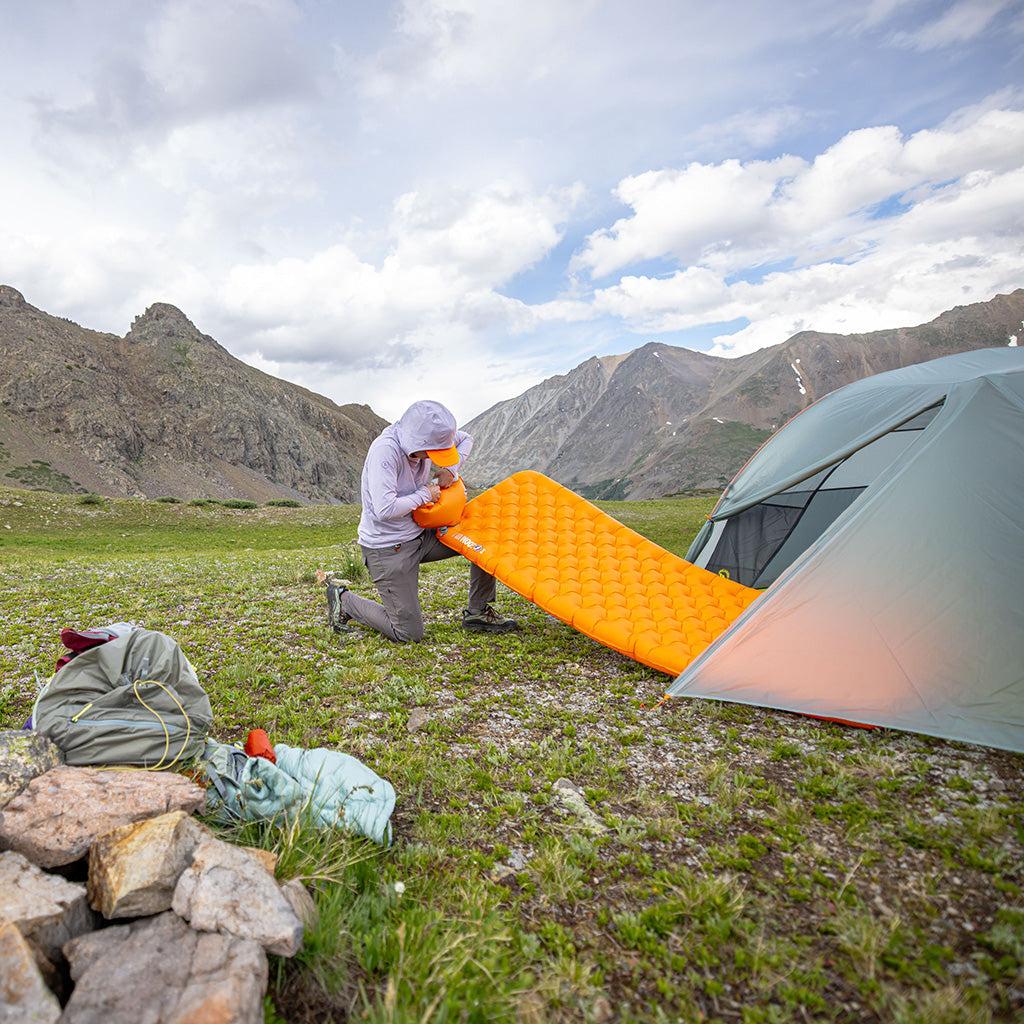 Inflatable sleeping pad in camping tent