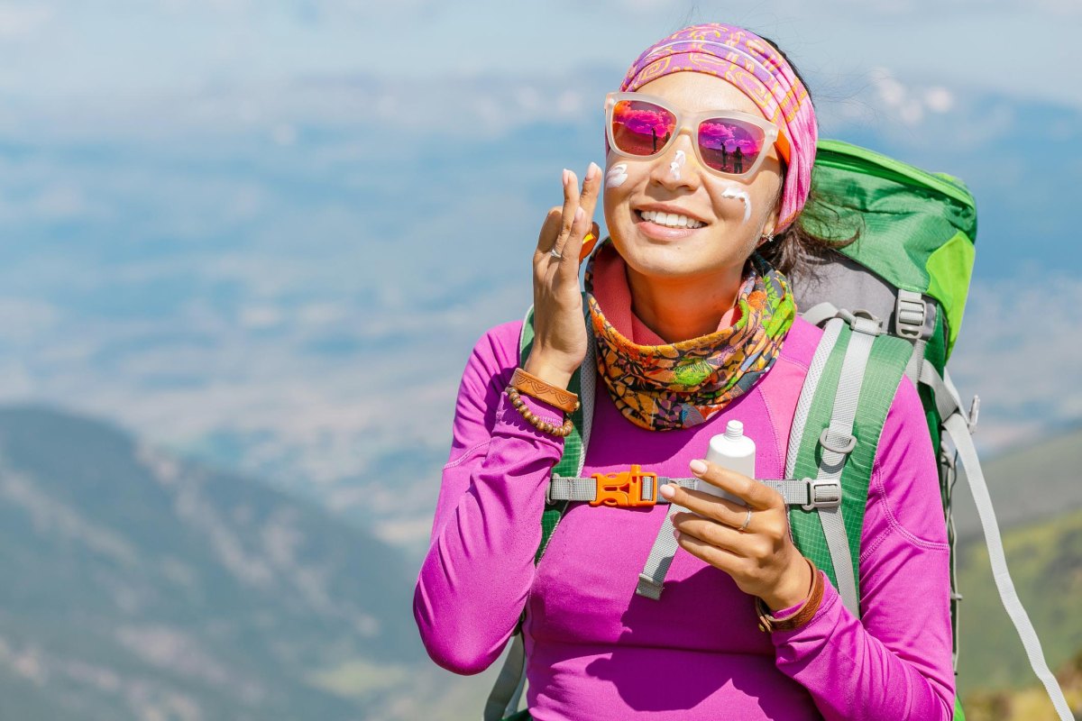 Hiker using sun protection outdoors