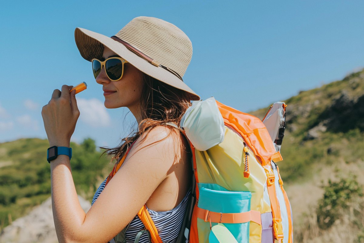 Hiker wearing hat sunglasses outdoors