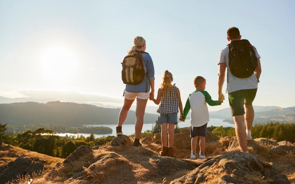 Family hiking at sunset viewpoint