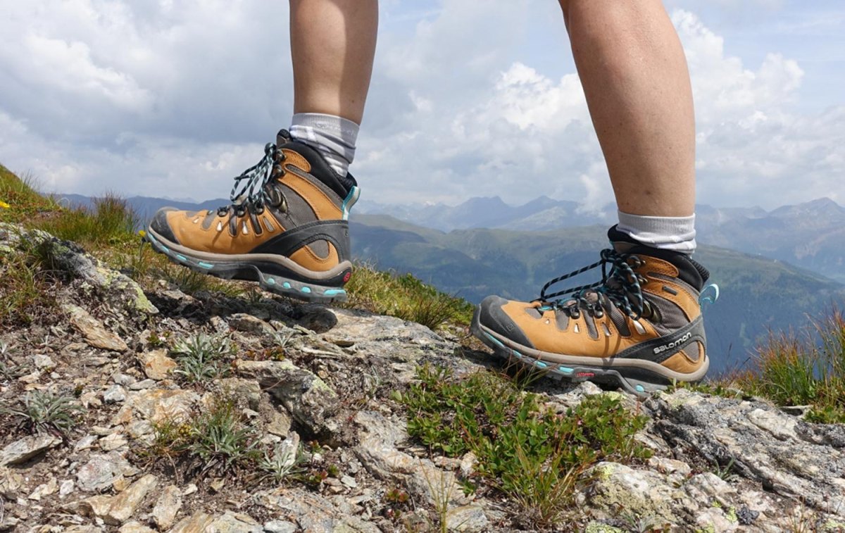 Women hiking boots on rocky mountain trail