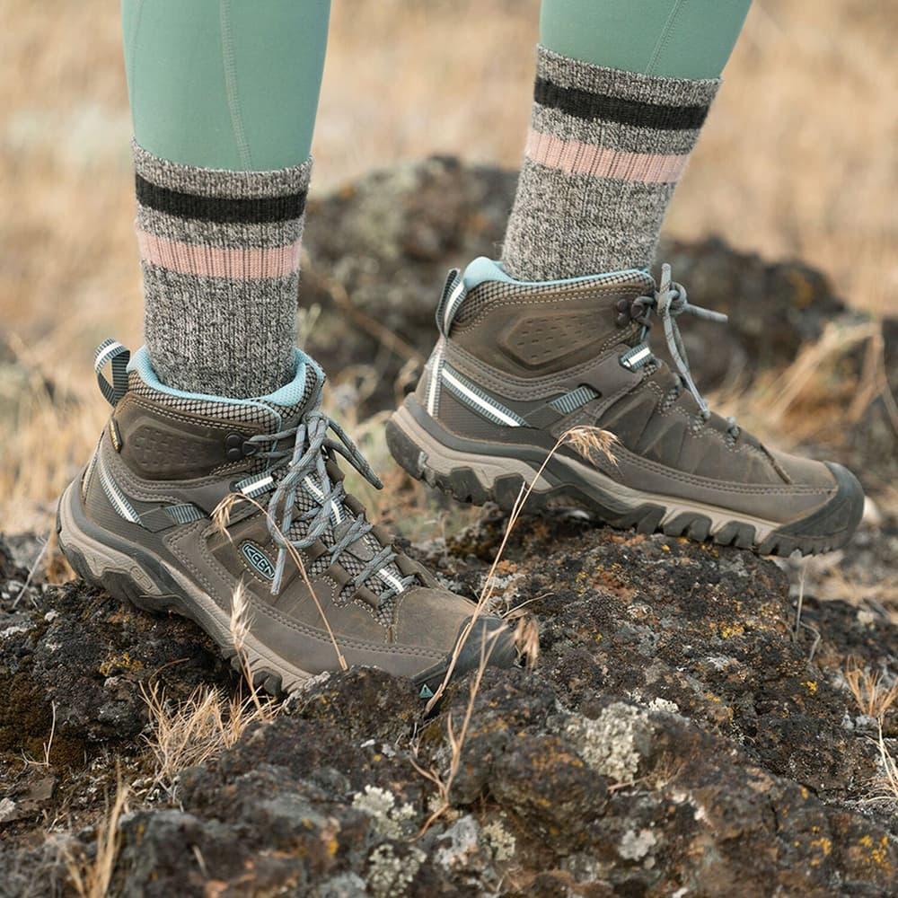 Women's hiking boots on rocky trail