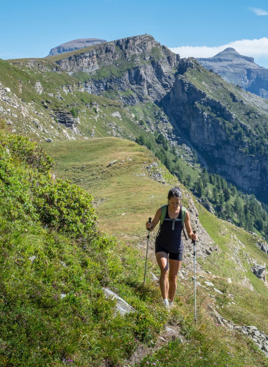 Woman using trekking poles on trail