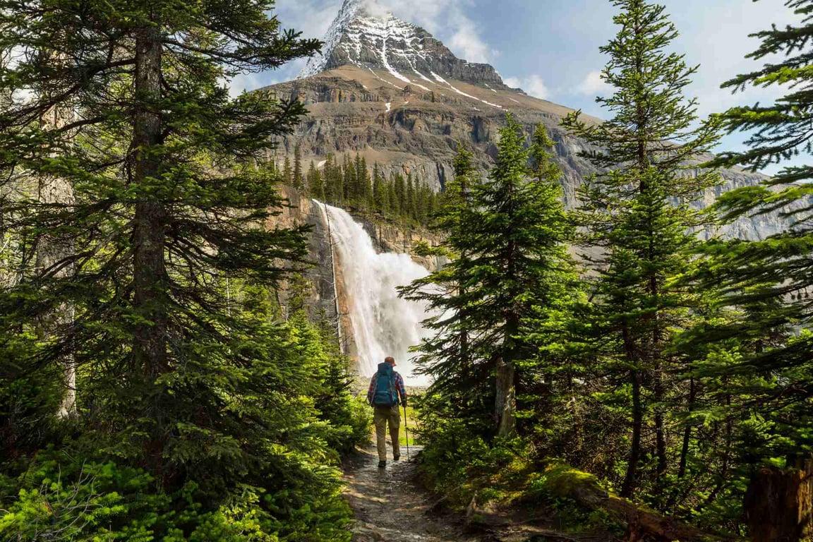 Hiker walking to waterfall