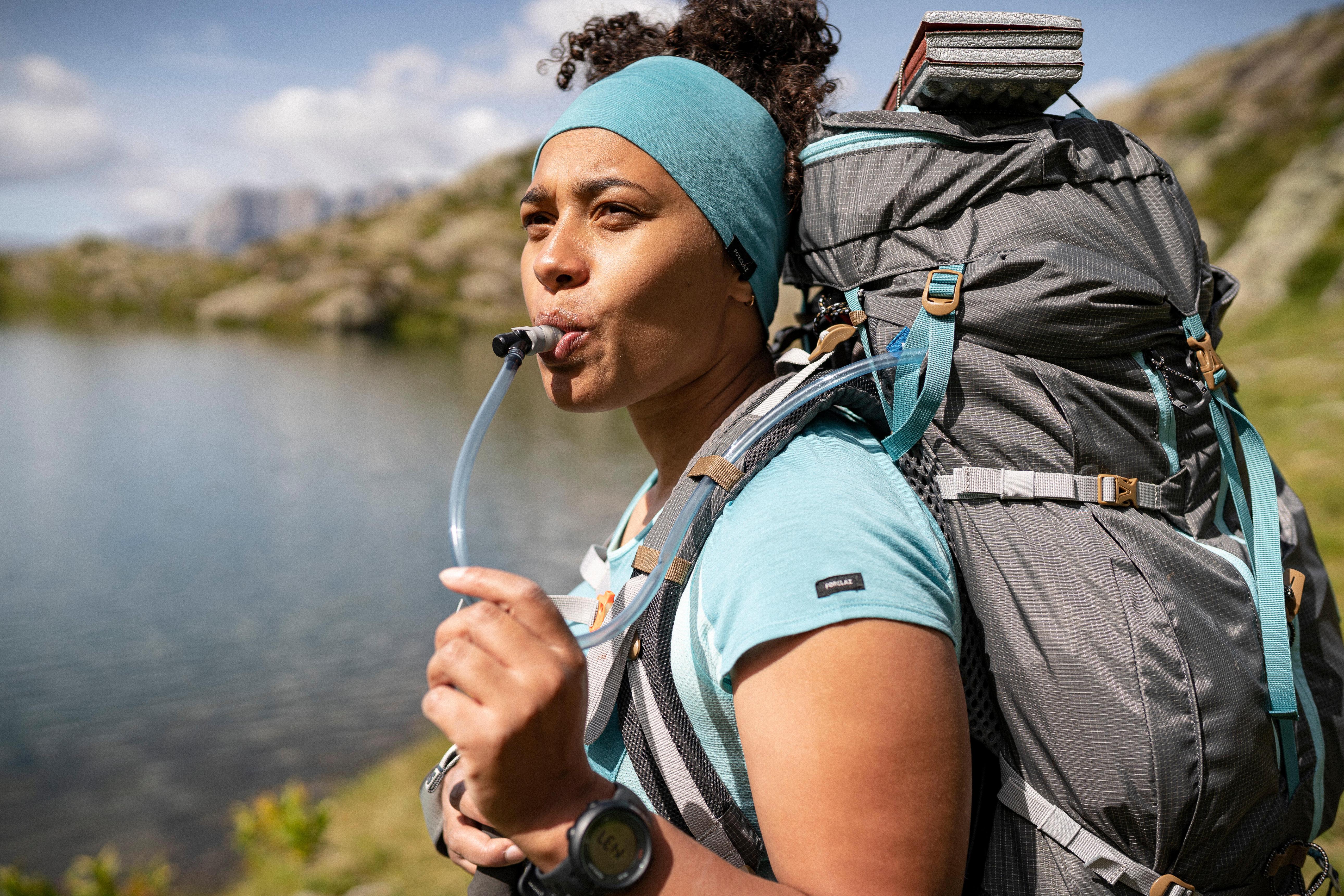 Hiker drinking water on trail