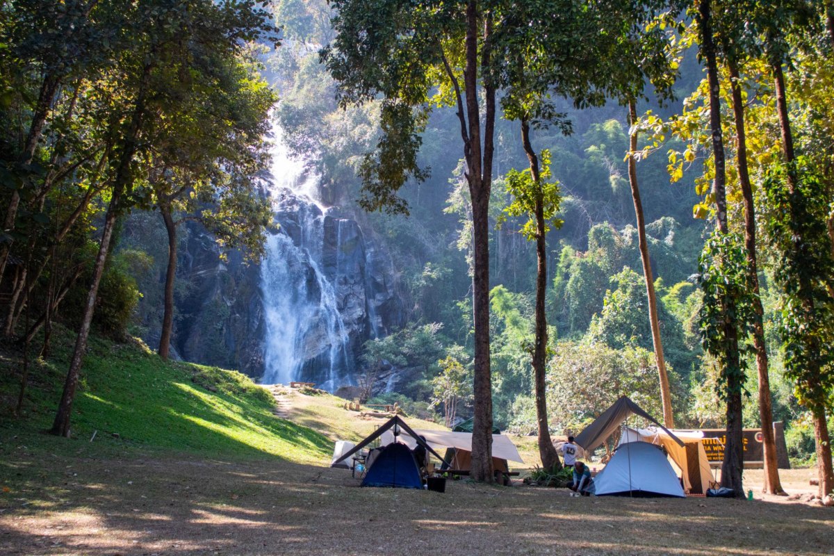 Couple exploring a waterfall cave hiking destination