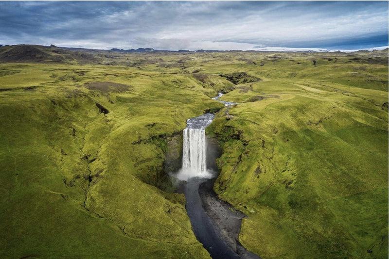 Couple exploring a waterfall cave hiking destination