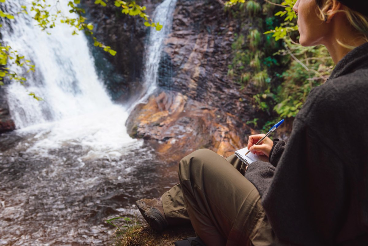 Couple exploring a waterfall cave hiking destination