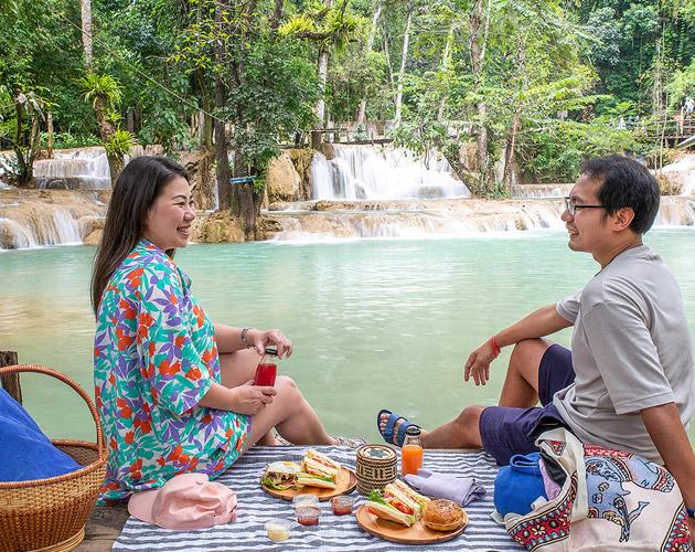 Couple exploring a waterfall cave hiking destination