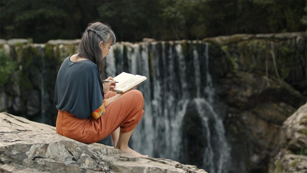 Couple exploring a waterfall cave hiking destination