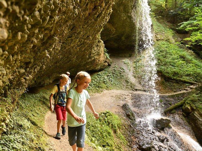 Children exploring an easy waterfall trail