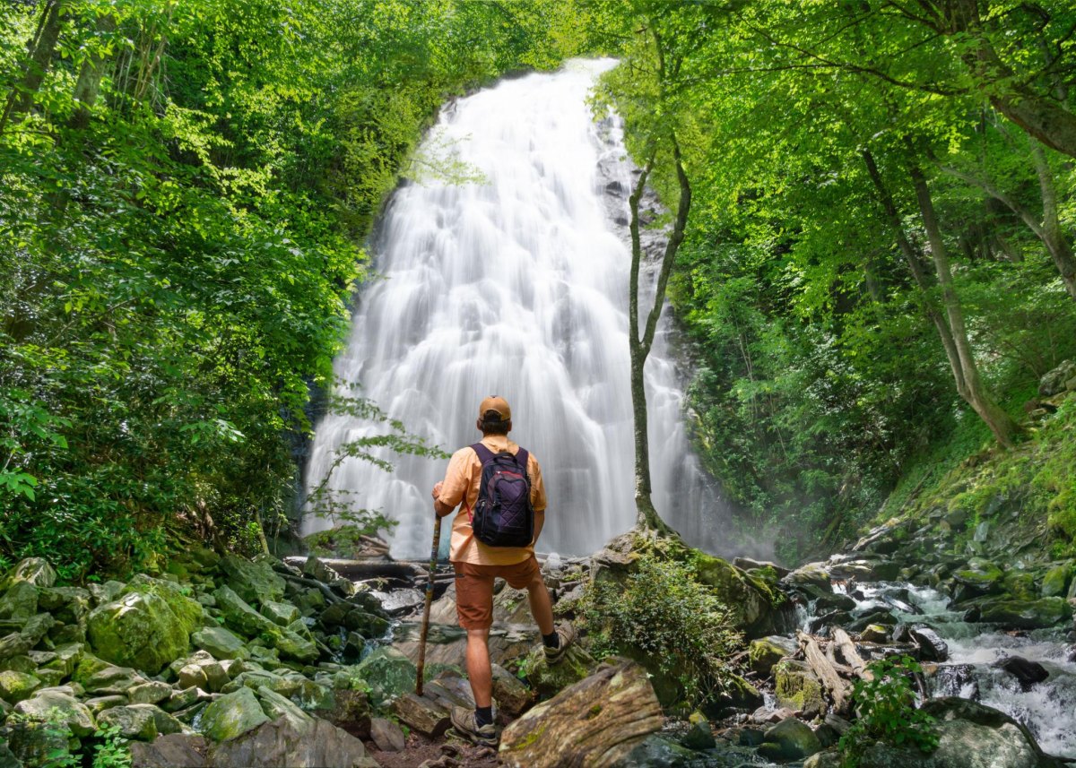 Couple exploring a waterfall cave hiking destination
