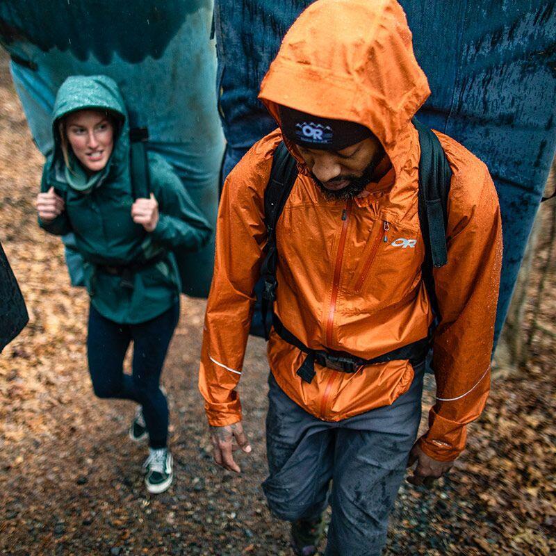 Hiker wearing waterproof jacket rainy trail