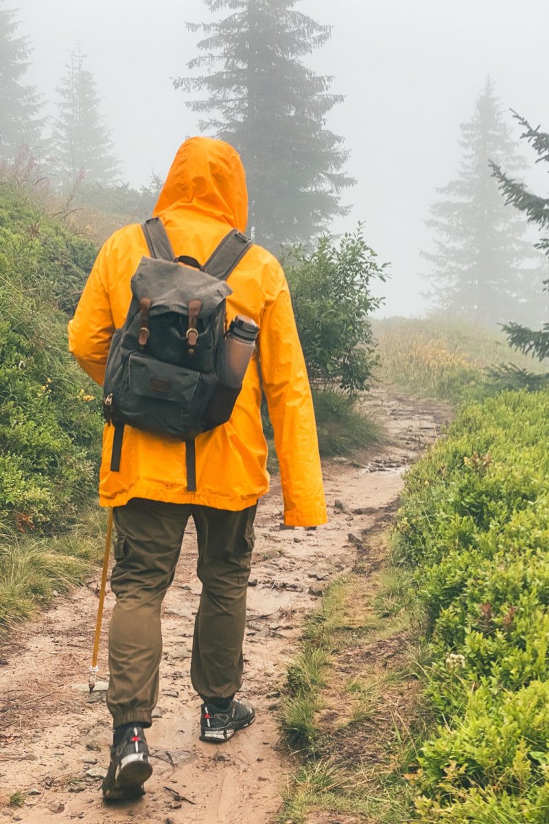 Woman hiker wearing rain jacket outdoors
